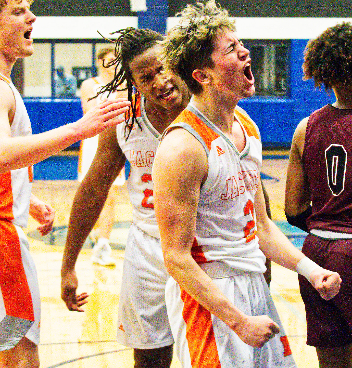 From left, Dawson Pendergrass, Trevion Sneed and T.J. Moreland react enthusiastically to Moreland scoring two points to put Mineola ahead by 12 in the fourth quarter while drawing a foul on Jefferson.  [see more shots, score prints]